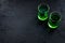 Absinthe shots on black background top view copy space