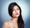 Absolutely gorgeous and amazingly flawless. Studio shot of a beautiful young woman posing against a blue background.