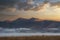 Absolutely stunning vibrant Autumn sunrise landscape image looking from Manesty Park in Lake Distict towards sunlit Skiddaw Range