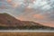 Absolutely stunning vibrant Autumn sunrise landscape image looking from Manesty Park in Lake Distict towards sunlit Skiddaw Range