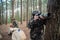 Absorbed boy with camera in forest