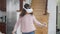 Absorbed teenage African American girl in VR headset boxing in augmented reality playing video game. Portrait of
