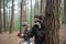 Absorbed woman with camera in forest