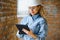 Absorbed in the work of a woman engineer working with a tablet on the background of the construction site. Portrait of a