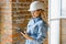 Absorbed in the work of a woman engineer working with a tablet on the background of the construction site. Portrait of a