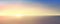 Abstract aerial panoramic view of sunrise over ocean. Nothing but blue bright sky and deep dark water. Beautiful serene scene.