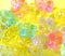 Abstract aesthetic background of decorative multicolor glass flowers  on yellow background
