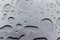 Abstract art background of large raindrops on stainless steel