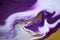 Abstract artwork marble liquid texture. Purple and gold background.