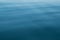 Abstract background of blue water, sea. Blurred background. Rippled water texture.