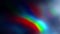 Abstract background with blurred rainbow colors on a black background.