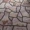 Abstract background of brown sandstone slabs with cracked lines on garden walkway