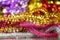 Abstract background with Christmas decorations, shiny multicolored tinsel. Gold, silver and red tinsel on a bright blurred bokeh b