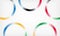 Abstract background with circles. Five rings of different colors with gradient are located around perimeter of sheet. Olympic colo