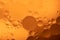 Abstract Background of circles and spheres of oil in water with bubbles macro close up ochre palette