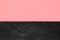 Abstract background composition of divided in the half matt pink color paper and black stone with copy space