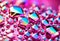 Abstract background with crystal diamonds in pink pearl color. Bright rainbow refraction. Glass crystal holographic background