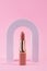 Abstract background with geometric forms for product presentation lipstick, lipgloss on pink background. arch to show