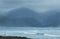 An abstract background image of the Pacific ocean coastal mountains in a rainy afternoon in New Zealand