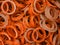 An abstract background of lush lava color coated metal ring parts