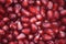 Abstract background macro photography image of fresh fruit with red shiny juicy pomegranate seeds close up