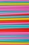 Abstract background from many multi-color straws.