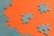 Abstract background of many puzzles on an orange background. The concept of teamwork