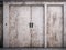 Abstract background. Metal doors in the wall, painted in white and rusted, weathered, dirty and grunge