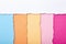 Abstract background of multi-colored stripes of torn cardboard lying vertically, top view