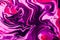 Abstract background of multicolored liquid paint swirls