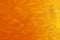 Abstract background of orange paint on a canvas. Chaotic strokes of paint of orange shades.