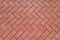 Abstract background from paving red tiles, bricks. Top view of the pavement pattern. Concept for construction, urban environment