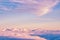 Abstract background with pink, purple and blue colors clouds. Sunset sky above the clouds.