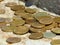 Abstract background with silver and gold colors coins spilled on stone ground.