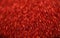 Abstract background and texture. Bright highlights on a red synthetic surface