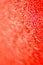 Abstract background and texture. Bright highlights on a red synthetic surface