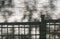 Abstract background of textured stone wall with shadows of trees and fence on it.