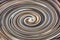 Abstract background, twisted lines in a spiral, bright brown-gray tones