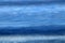 Abstract background of waves on beach in cool color scheme