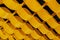 Abstract background of yellow wavy suspended ceiling, waves arranged in rows