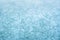 Abstract blue background made of frozen ice crystals on a pond.