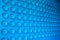 Abstract blue background. Sucker close up. Pattern of plastic cups.