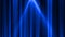 Abstract blue curtain background in a theater or stage illuminated by spotlight