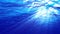 Abstract blue deep water with the sun\'s rays