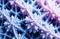 Abstract blue and purple fractal pattern with symmetrical spiked structures. AI generation