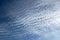 Abstract blue sky with spindrift clouds