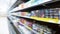 Abstract blur image of supermarket background. Defocused shelves with fresh products for sale. Grocery Store. Retail industry.