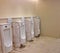 Abstract blur row of urinals men public toilet