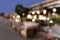 Abstract blured defocused image of European cosy cafe at dusk with beautiful bokeh lights. Copy space.