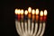 Abstract blurred background of jewish holiday Hanukkah background with menorah (traditional candelabra) Burning candles over black
